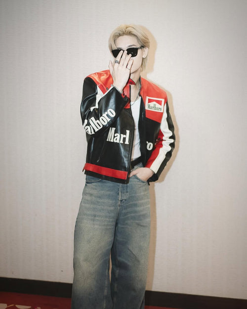 Person wearing a LZRUS Black Marlboro Leather Jacket – Vintage Racing Streetwear Style and sunglasses against a plain background
