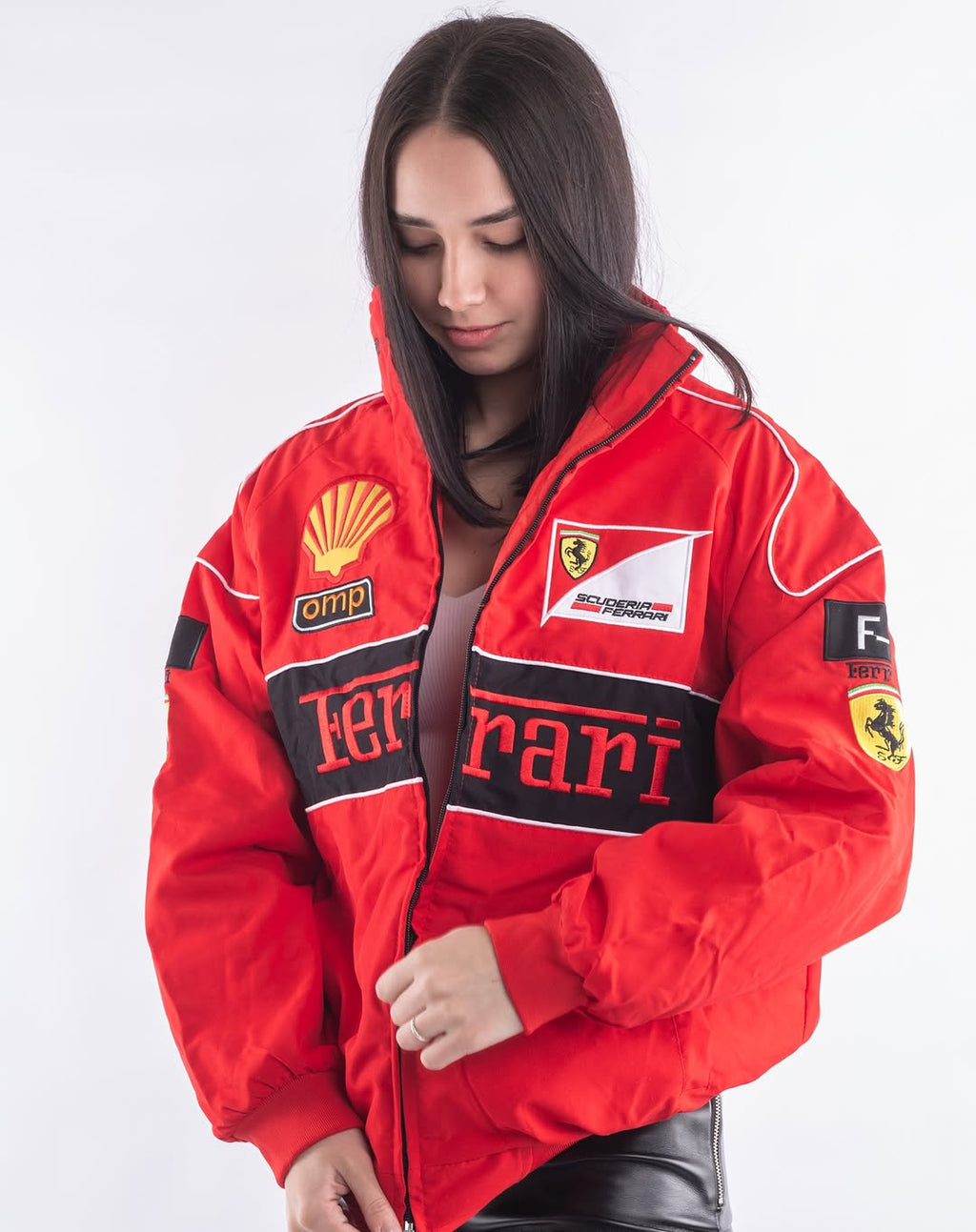 Woman wearing a red Ferrari jacket with various logos on a white background