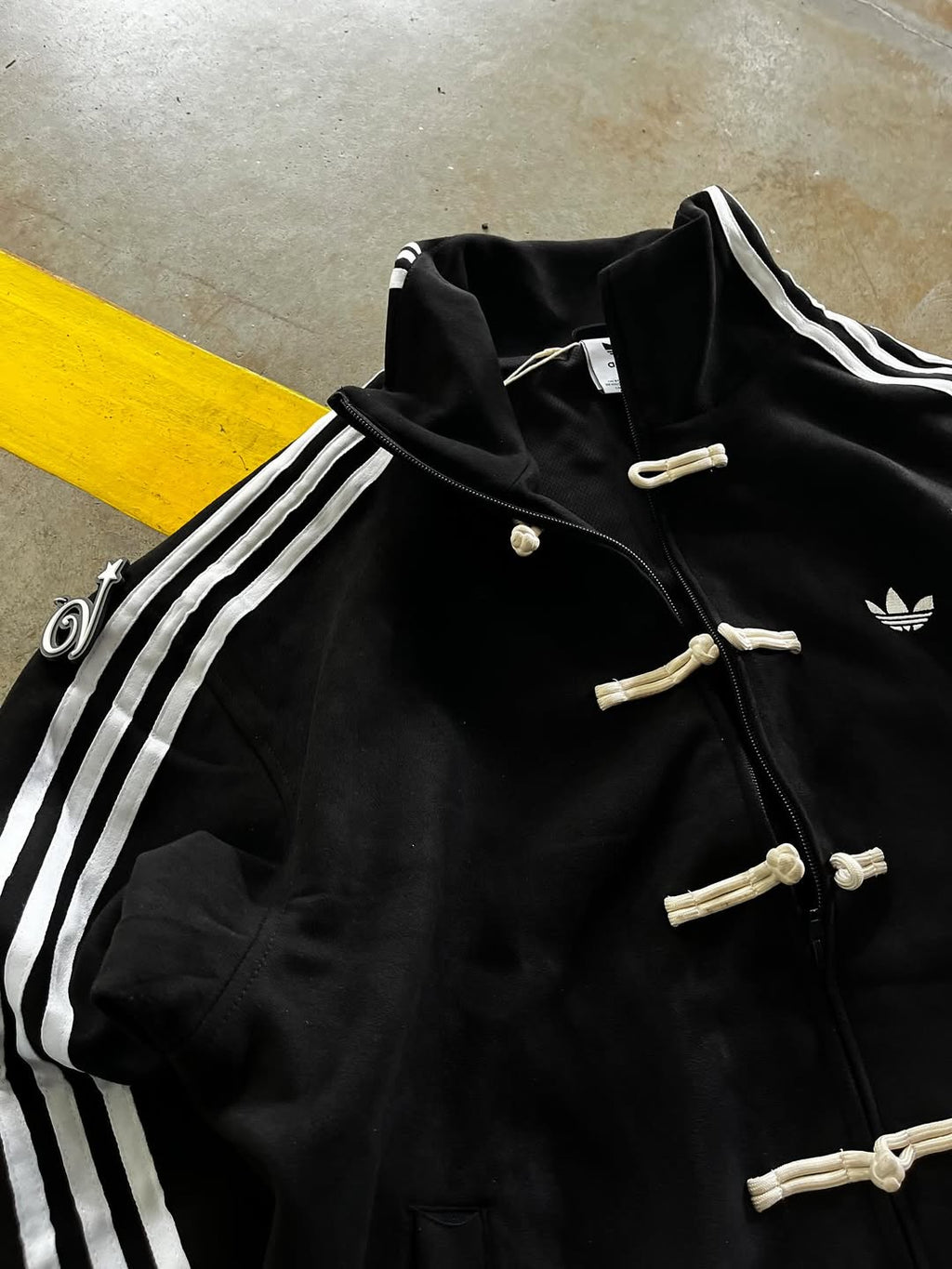 Close-up of Black CNY Jacket Chinese knot button closure and 420 GSM vegan suede texture – LZRUS Black Chinese New Year Jacket detail shot