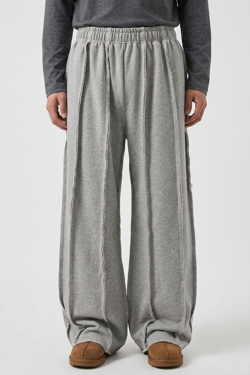 LZRUS exposed seam sweatpants men India – front waist-down view showing multiple vertical raw seam lines on wide leg grey deconstructed sweatpants