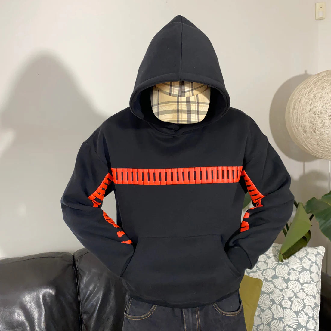 Black hoodie with red accents worn by a person indoors.
Cute couple gift hoodie – streetwear style by LZRUS