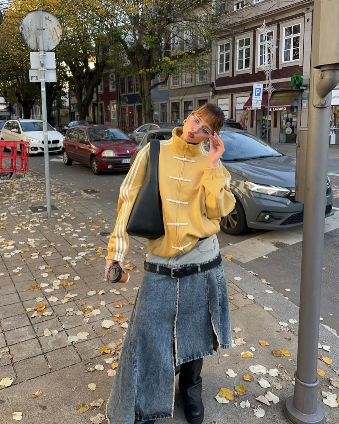 Women in Chinese New Year Jacket Mustard Yellow Suede Finish and denim skirt on a city street with cars and buildings in the background. Buy CNY Jacket India Online – LZRUS