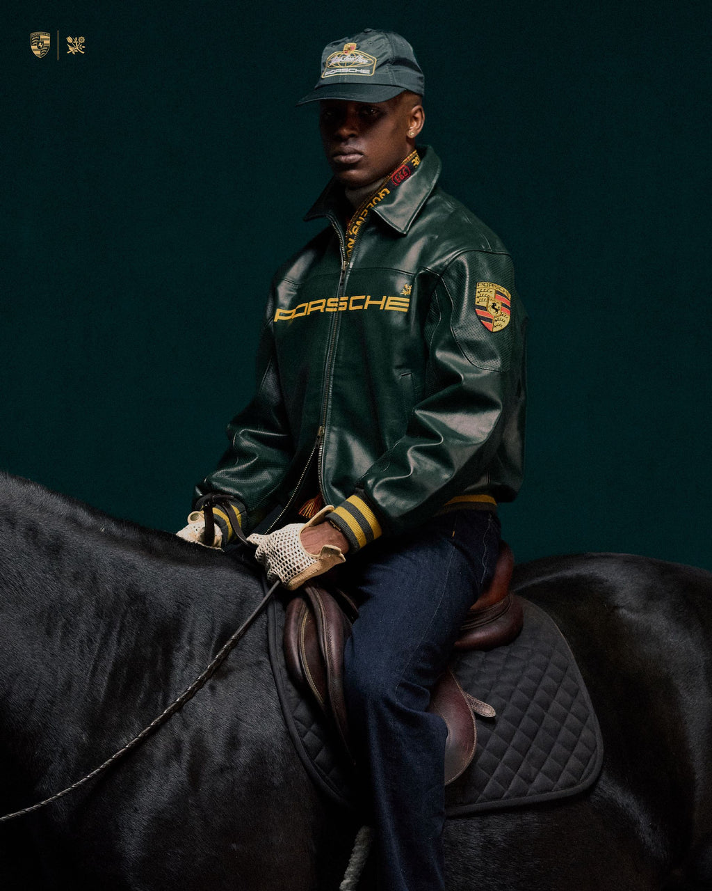 Person wearing a Porsche 993 jacket streetwear fit sitting on a horse against a dark background
