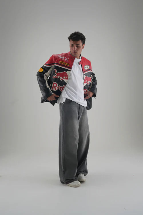 Person wearing a LZRUS Red Bull biker vintage leather jacket showcasing retro racing patches and detailed embroidery.