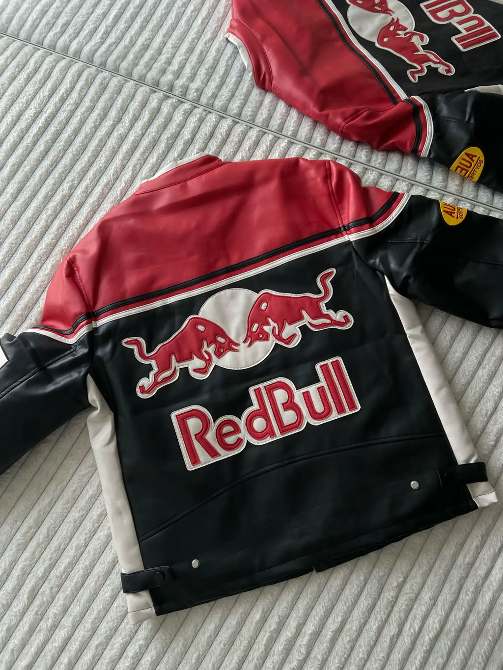 Back view of LZRUS Red Bull Leather Vintage Jacket – retro streetwear biker style in black, red, and white.