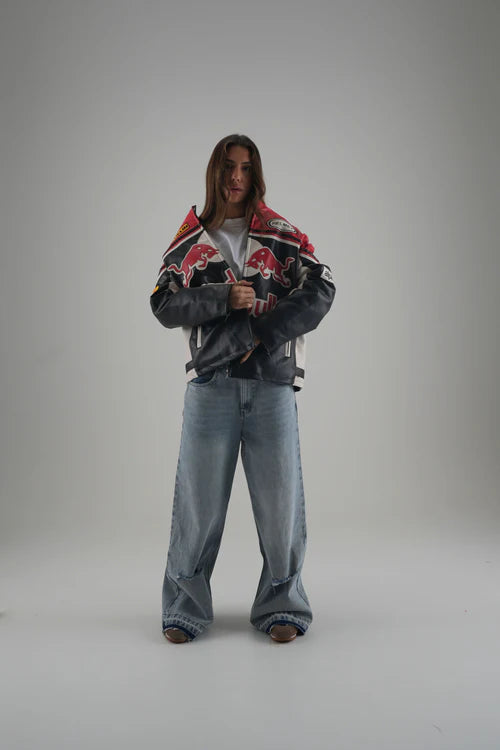 Women Model wearing LZRUS Red Bull Vintage Leather Jacket styled with casual streetwear outfit.