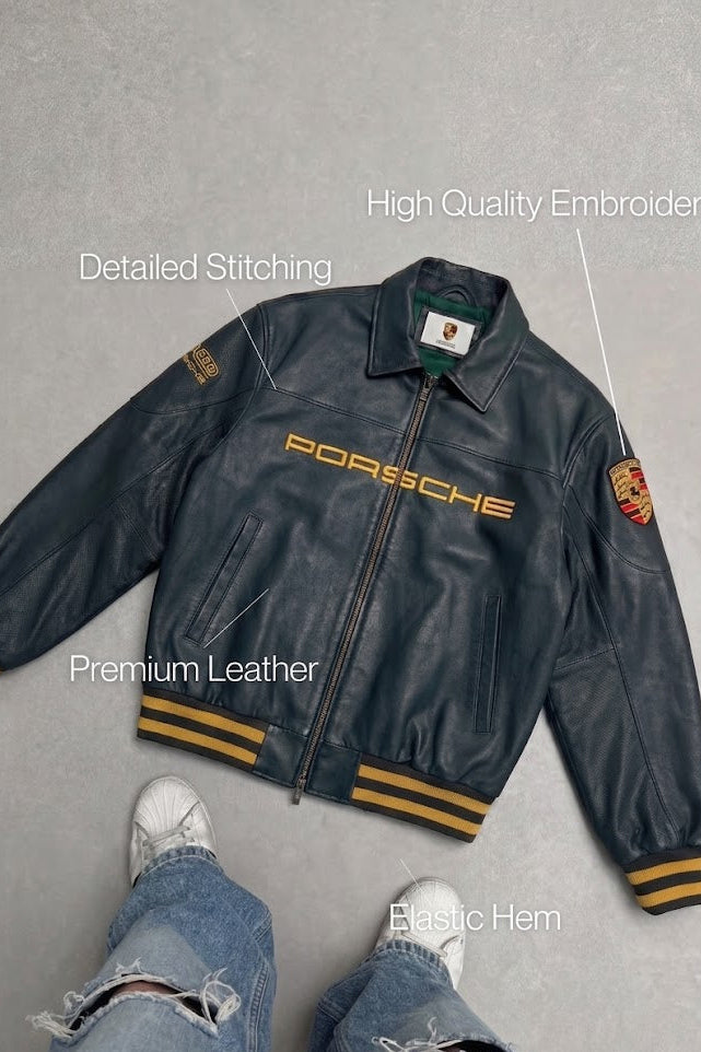 Black Porsche leather jacket detail flat lay with distressed vintage grain and gold embroidery – LZRUS