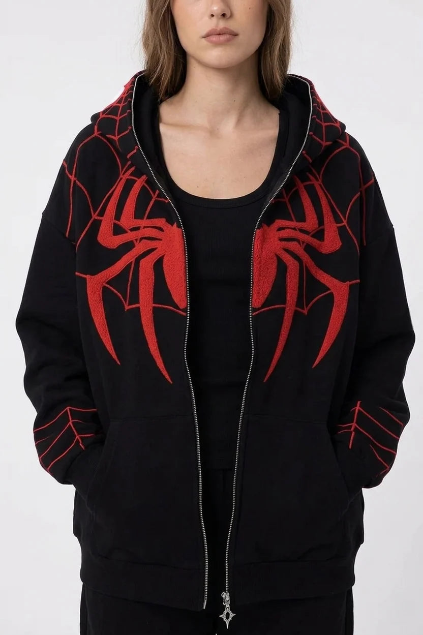 Woman wearing oversized black Spiderman embroidered zip up hoodie with red chenille spider and web sleeves LZRUS