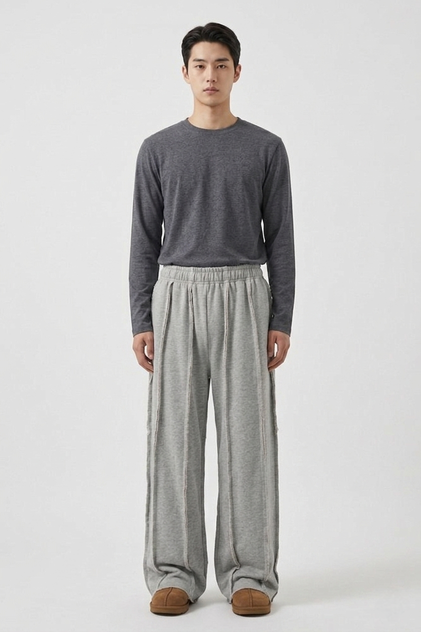 LZRUS exposed seam sweatpants for men India – full body front view styled with grey long sleeve top, wide leg grey deconstructed streetwear outfit LZRUS