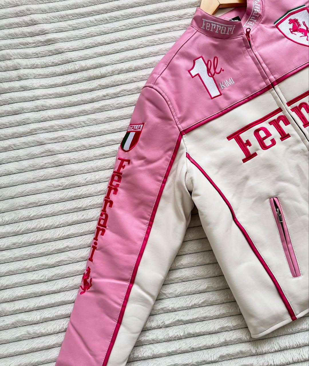 Close-up of LZRUS Pink Ferrari Leather Jacket sleeve and shoulder with embroidered Ferrari branding