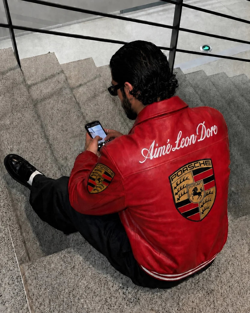 Oversized red Porsche leather jacket rear drape on stairs, drop shoulder streetwear fit – LZRUS