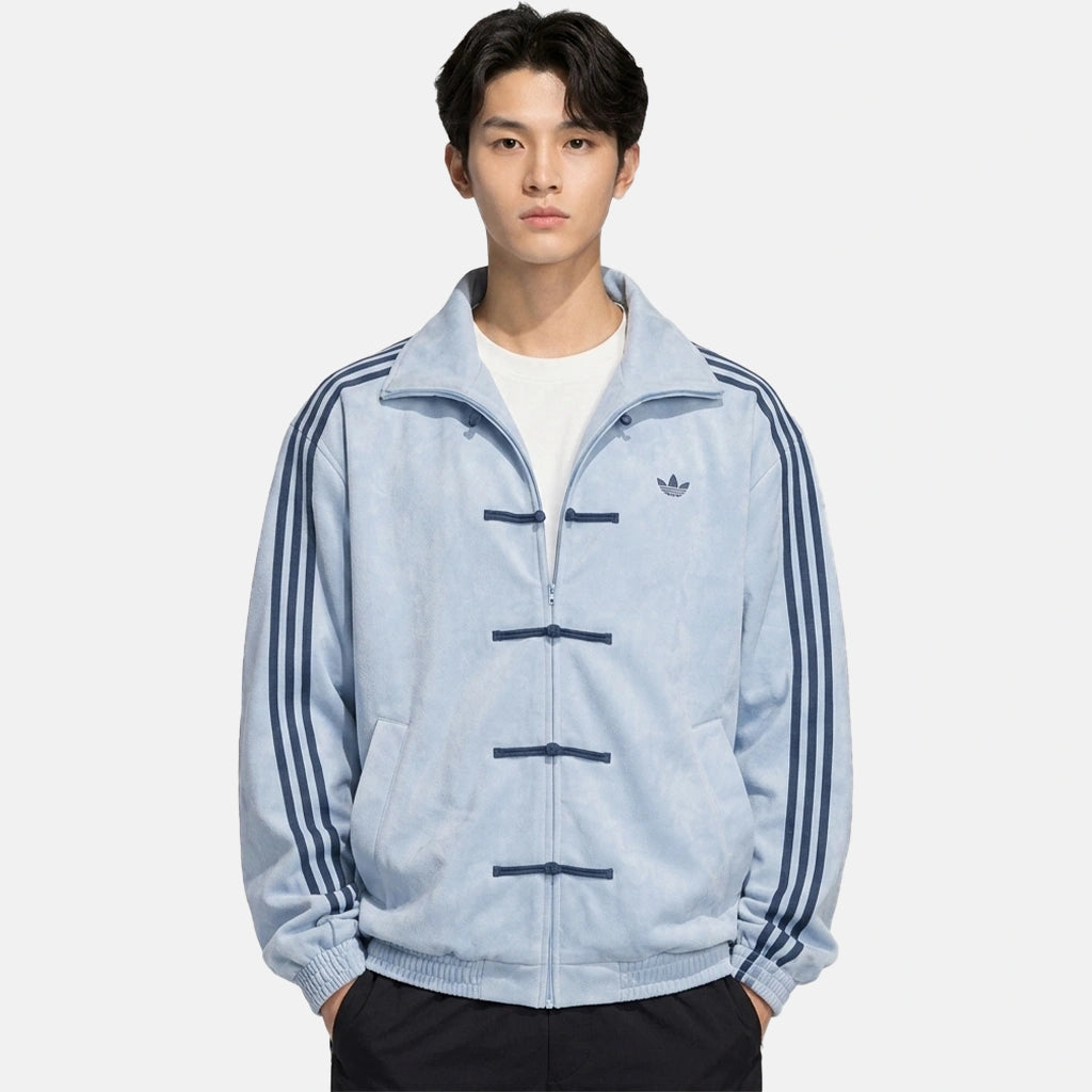 Man wearing the sky blue CNY jacket for men, oversized fit styled with a white tee and black trousers