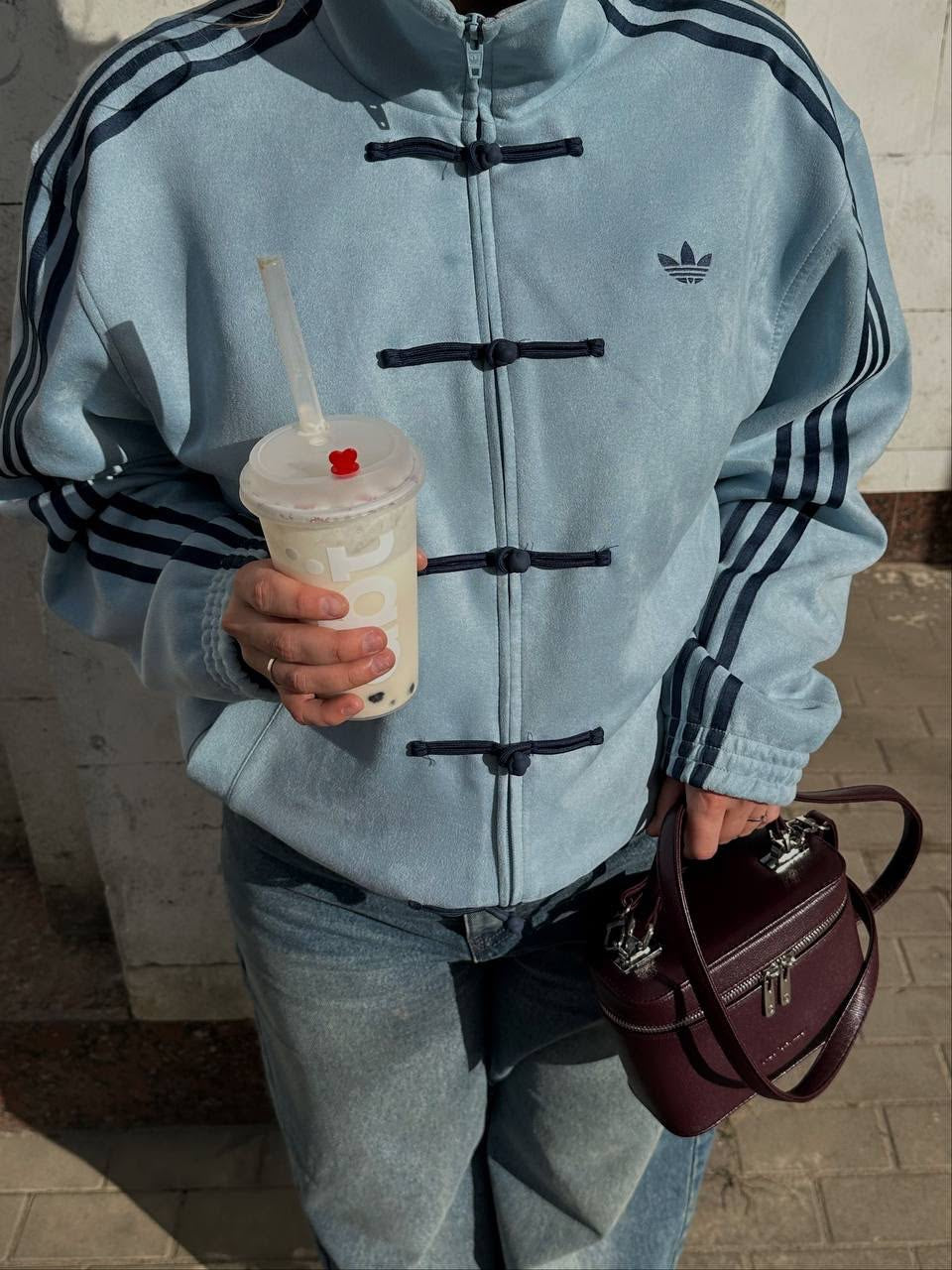 Close-up of the pankou knot button closures and brushed vegan suede texture on the sky blue knot jacket