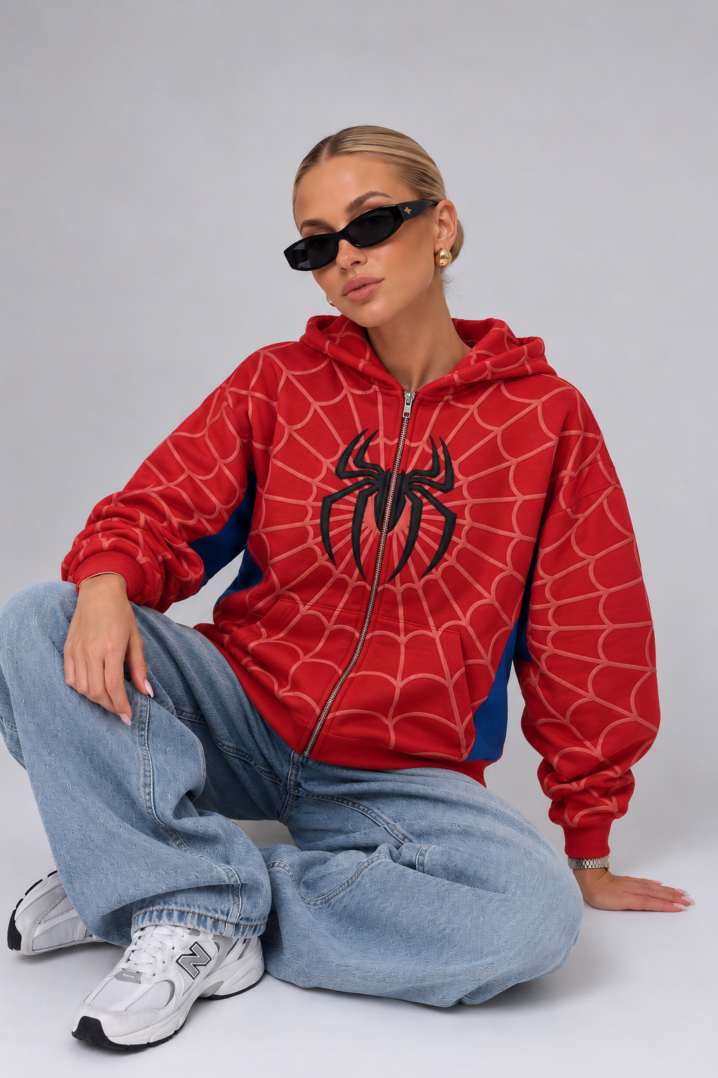 Spider hoodie for women styled oversized with light wash baggy jeans and white chunky sneakers