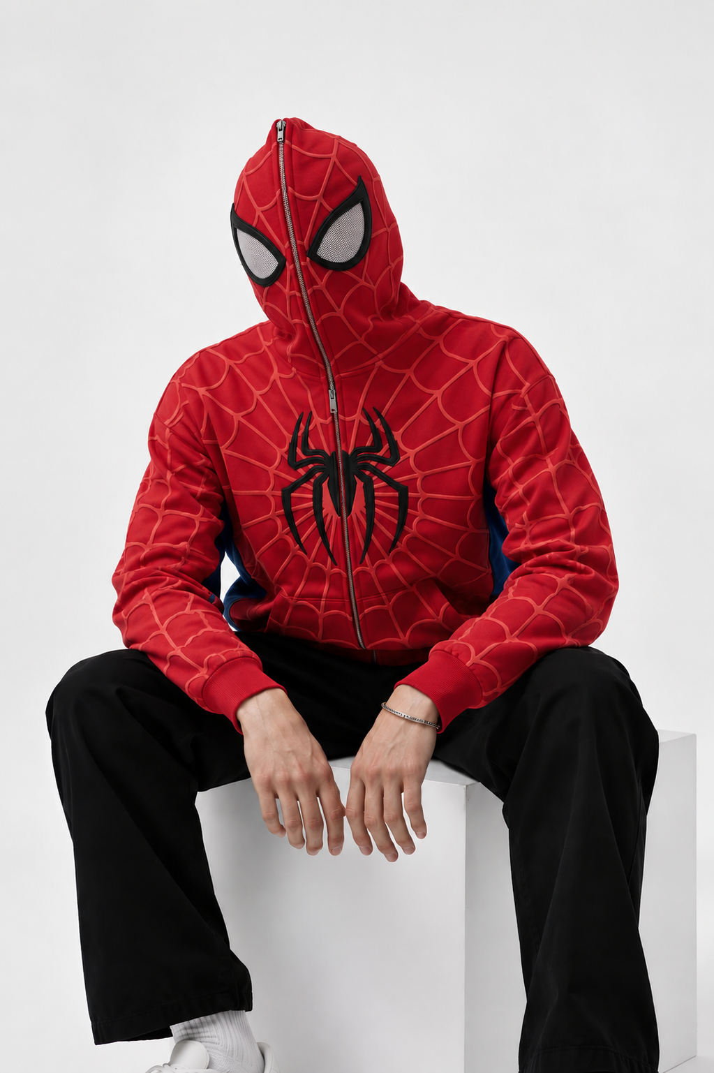 Spider web zip up hoodie zipped fully over the hood with mesh eye panels, styled with black wide leg trousers